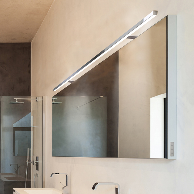 A modern bathroom featuring an elegant washbasin, a large mirror and stylish lighting provided by an LD 8104 A with two mounting arms