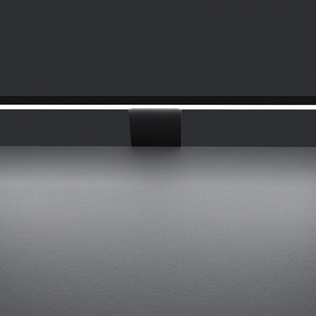 A close-up of an elegant black pendant light with soft lighting, ideal for modern interior designs
