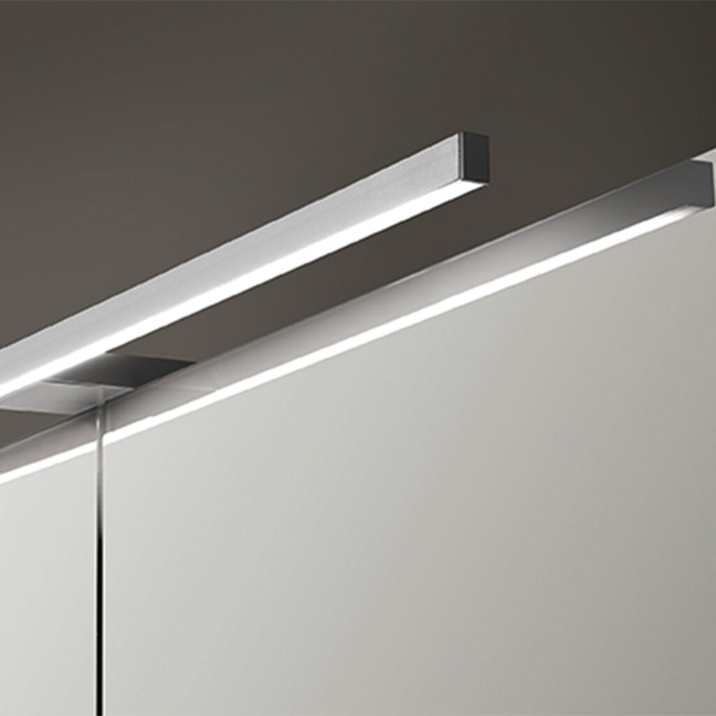 An elegant silver LED lighting system illuminates a mirror, perfect for modern living spaces