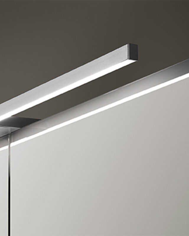 Ein elegantes silbernes LED-Lichtsystem beleuchtet einen Spiegel, perfekt für moderne Wohnräume.